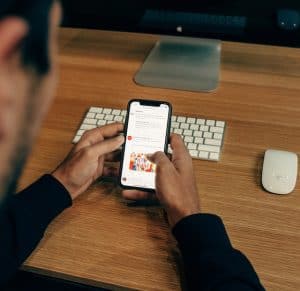 The pictur eis of a person reading a newsletter on his phone.