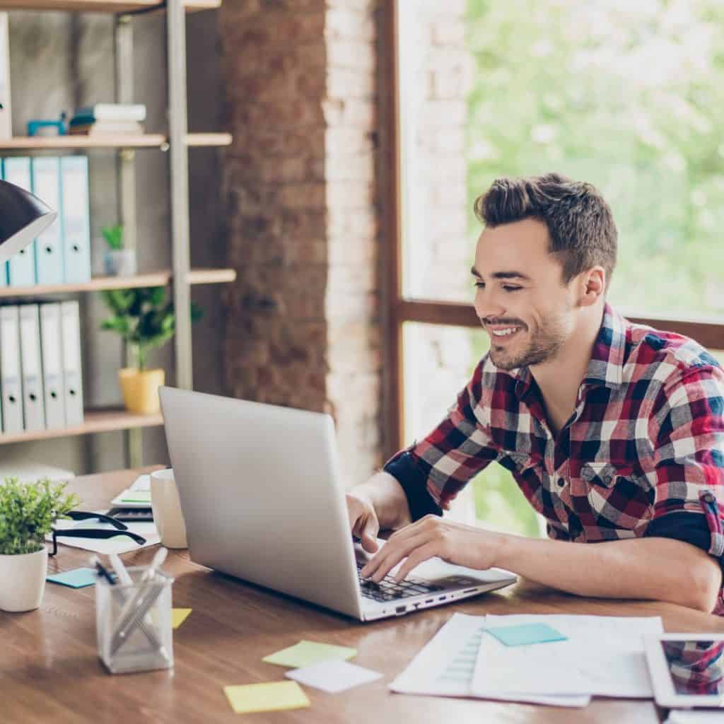 An entrepreneur blogging on a laptop | a featured image from the LOJO article, "How Often Should I Be Blogging?"