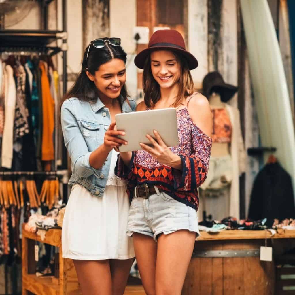 Two ladies signing up for brand notifications | a featured image from "How Do I Build Trust Online (For My Brand)?" | LOJO Marketing